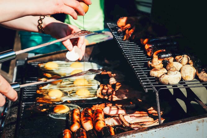 A picture containing person cooking on a bbq